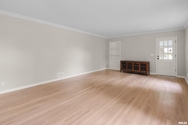 802 W Main St, Vienna, IL 62995 - unfurnished living room with light wood-type flooring, crown molding, baseboards, and built in shelves