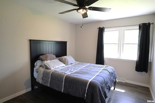 bedroom with baseboards, wood finished floors, and a ceiling fan