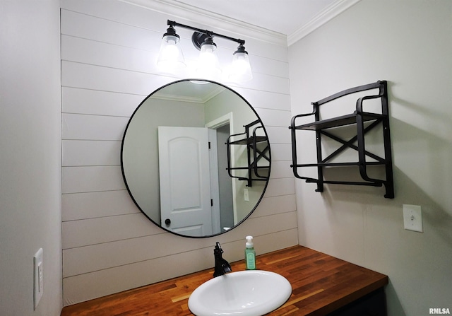 bathroom with a sink and ornamental molding
