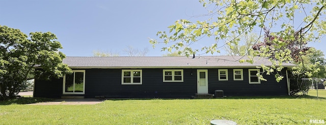 back of house with a lawn and cooling unit