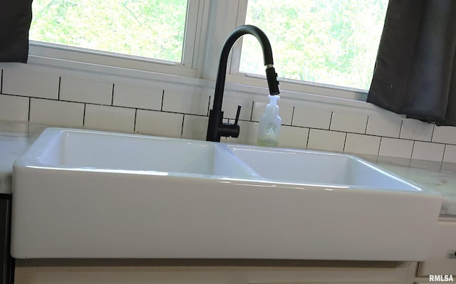 kitchen view of a sink and light countertops