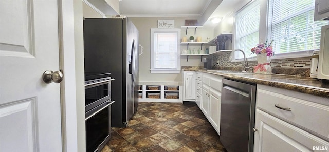 401 E 5th St, Mount Carmel, IL 62863 - kitchen featuring stainless steel dishwasher, a sink, range, white cabinets, and decorative backsplash
