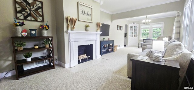 401 E 5th St, Mount Carmel, IL 62863 - living room with arched walkways, carpet, a chandelier, crown molding, and a fireplace with flush hearth