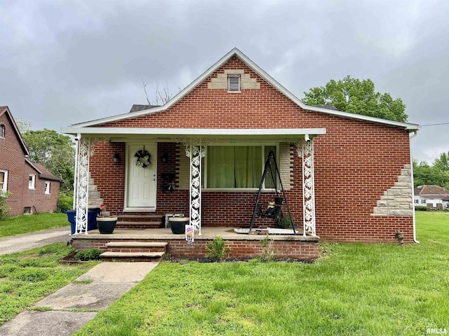 405 E Saint Louis St, West Frankfort, IL 62896 - bungalow with a front lawn, covered porch, and brick siding