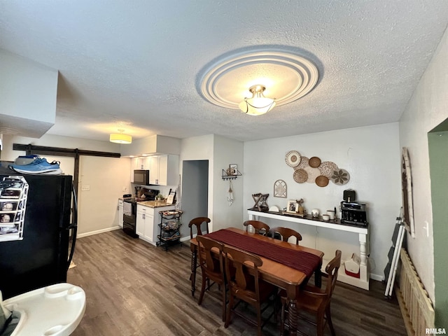405 E Saint Louis St, West Frankfort, IL 62896 - dining room featuring a barn door, dark wood-style floors, and a textured ceiling