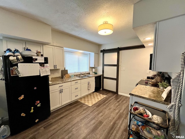 405 E Saint Louis St, West Frankfort, IL 62896 - kitchen with black appliances, a sink, a barn door, dark wood finished floors, and white cabinets