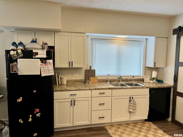 405 E Saint Louis St, West Frankfort, IL 62896 - kitchen featuring black appliances, a sink, light wood-style flooring, white cabinetry, and a barn door