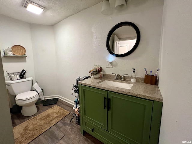 405 E Saint Louis St, West Frankfort, IL 62896 - half bath with a textured ceiling, wood finished floors, toilet, vanity, and baseboards