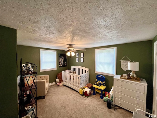 405 E Saint Louis St, West Frankfort, IL 62896 - bedroom with a textured ceiling, carpet flooring, ceiling fan, baseboards, and a crib