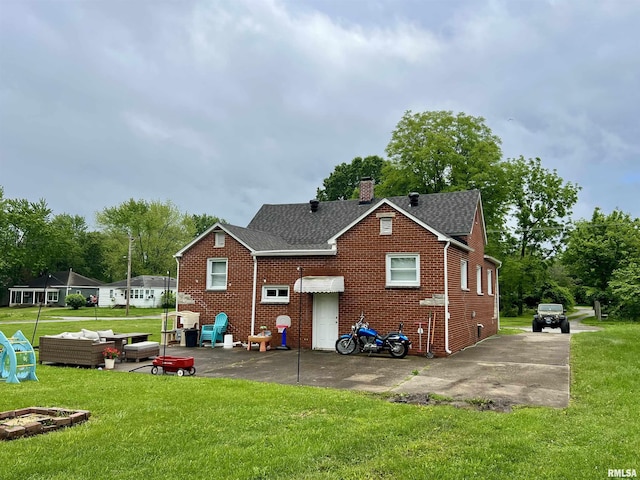 405 E Saint Louis St, West Frankfort, IL 62896 - rear view of house featuring a lawn, roof with shingles, a chimney, and brick siding