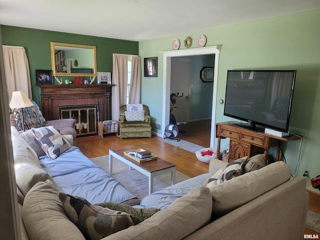 1806 Pace Ave, Mount Vernon, IL 62864 - living area featuring wood finished floors, a brick fireplace, and baseboards