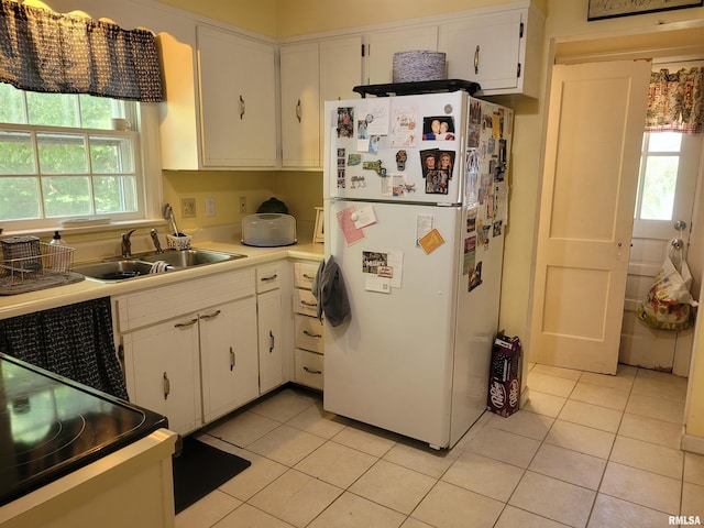 1806 Pace Ave, Mount Vernon, IL 62864 - kitchen with freestanding refrigerator, light tile patterned floors, white cabinetry, and a sink