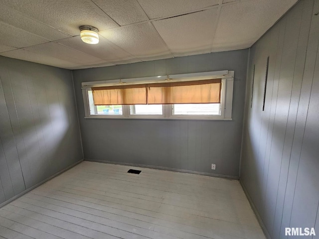 2307 Perkins Ave Unit A, Mount Vernon, IL 62864 - unfurnished room featuring light wood-style flooring, wood walls, and baseboards