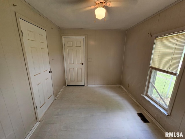 2307 Perkins Ave Unit A, Mount Vernon, IL 62864 - unfurnished room with light wood finished floors, baseboards, a ceiling fan, and wooden walls