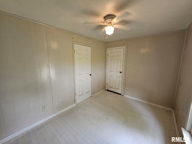 2307 Perkins Ave Unit A, Mount Vernon, IL 62864 - empty room with light wood-type flooring, a ceiling fan, wooden walls, and baseboards