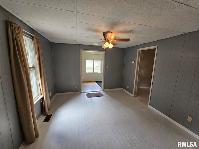 2307 Perkins Ave Unit A, Mount Vernon, IL 62864 - empty room with wood finished floors, ceiling fan, baseboards, and wooden walls