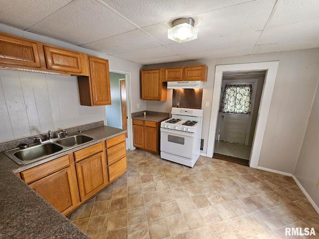 2307 Perkins Ave Unit A, Mount Vernon, IL 62864 - kitchen featuring white gas range oven, a sink, brown cabinetry, a paneled ceiling, and wooden walls