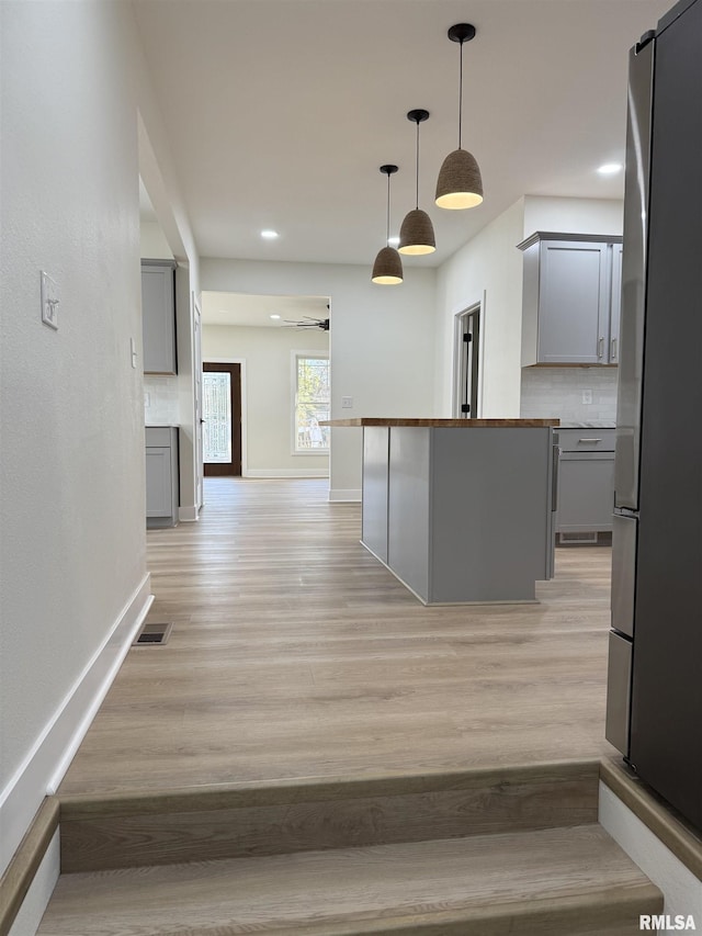 920 E 3rd St, Centralia, IL 62801 - kitchen with gray cabinets, freestanding refrigerator, decorative backsplash, light wood-style flooring, and recessed lighting