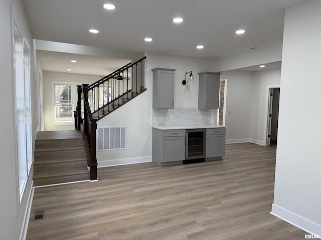 920 E 3rd St, Centralia, IL 62801 - kitchen with gray cabinets, beverage cooler, baseboards, light wood finished floors, and recessed lighting