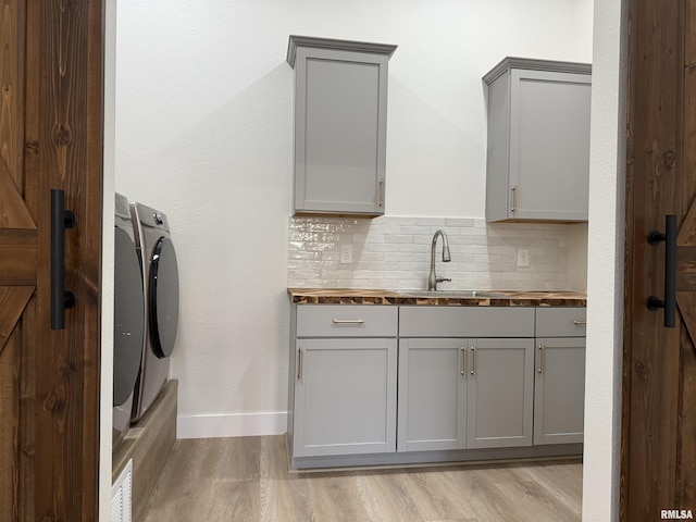 920 E 3rd St, Centralia, IL 62801 - clothes washing area featuring cabinet space, light wood finished floors, and baseboards