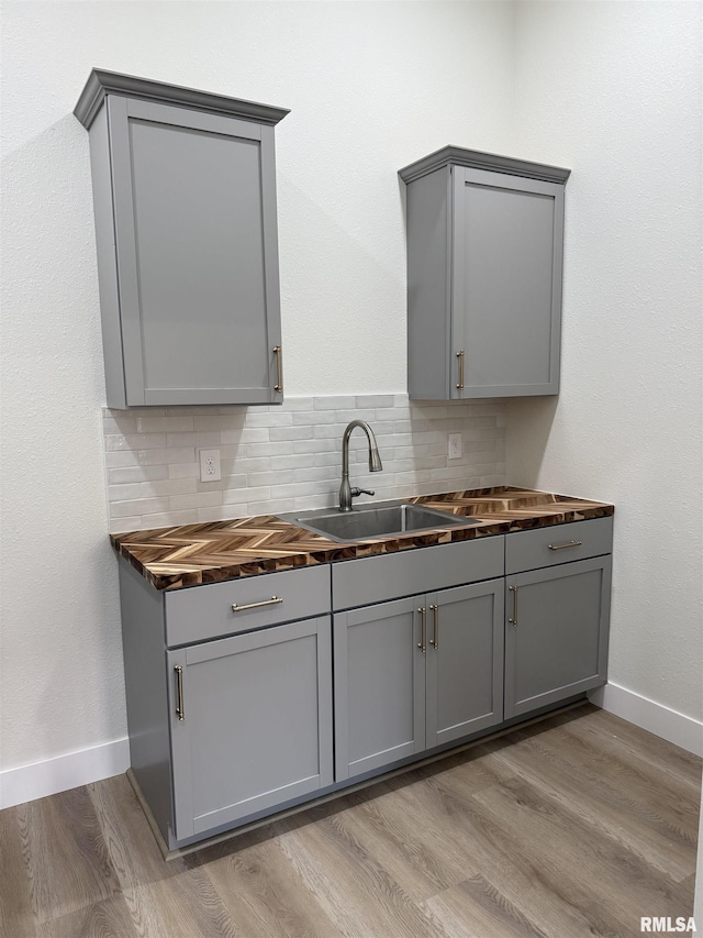 920 E 3rd St, Centralia, IL 62801 - kitchen with gray cabinets, a sink, and wood counters