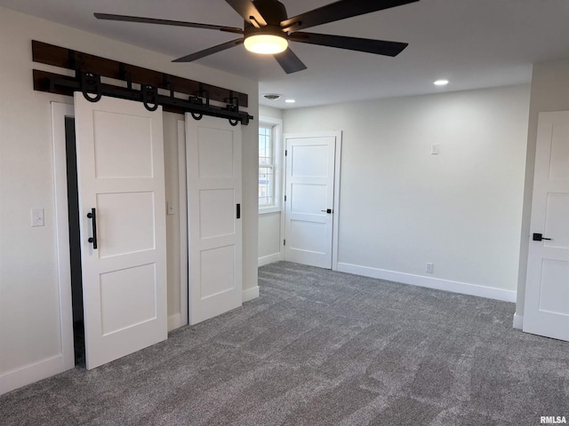 920 E 3rd St, Centralia, IL 62801 - unfurnished bedroom featuring carpet flooring, a barn door, baseboards, recessed lighting, and ceiling fan