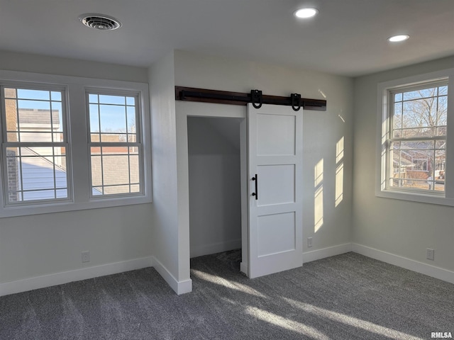 920 E 3rd St, Centralia, IL 62801 - spare room with baseboards, a barn door, dark carpet, and recessed lighting