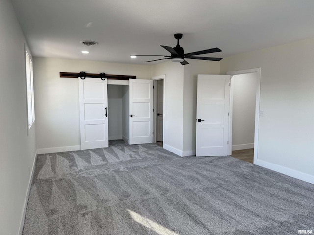 920 E 3rd St, Centralia, IL 62801 - unfurnished bedroom featuring baseboards, carpet, recessed lighting, a barn door, and a ceiling fan