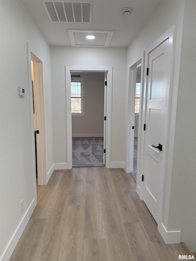 920 E 3rd St, Centralia, IL 62801 - hallway featuring attic access, light wood-style flooring, and baseboards