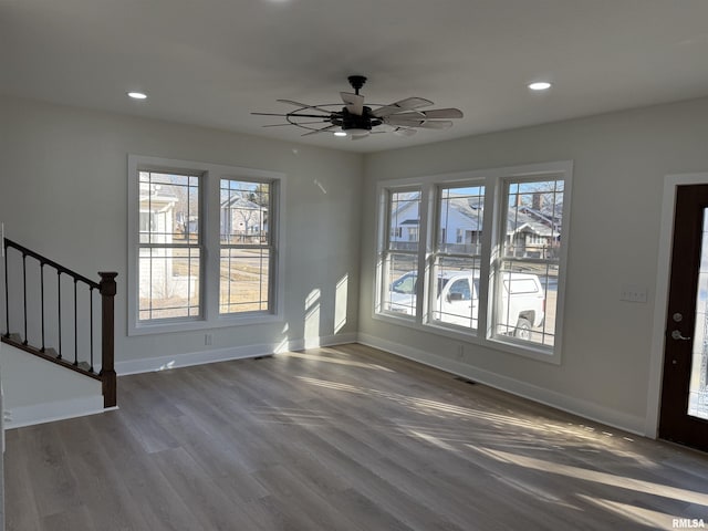 920 E 3rd St, Centralia, IL 62801 - unfurnished living room with baseboards, wood finished floors, recessed lighting, stairway, and ceiling fan