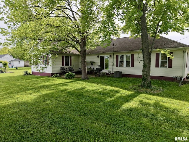 105 E Yung St, Sesser, IL 62884 - back of property featuring a yard, cooling unit, and a patio area