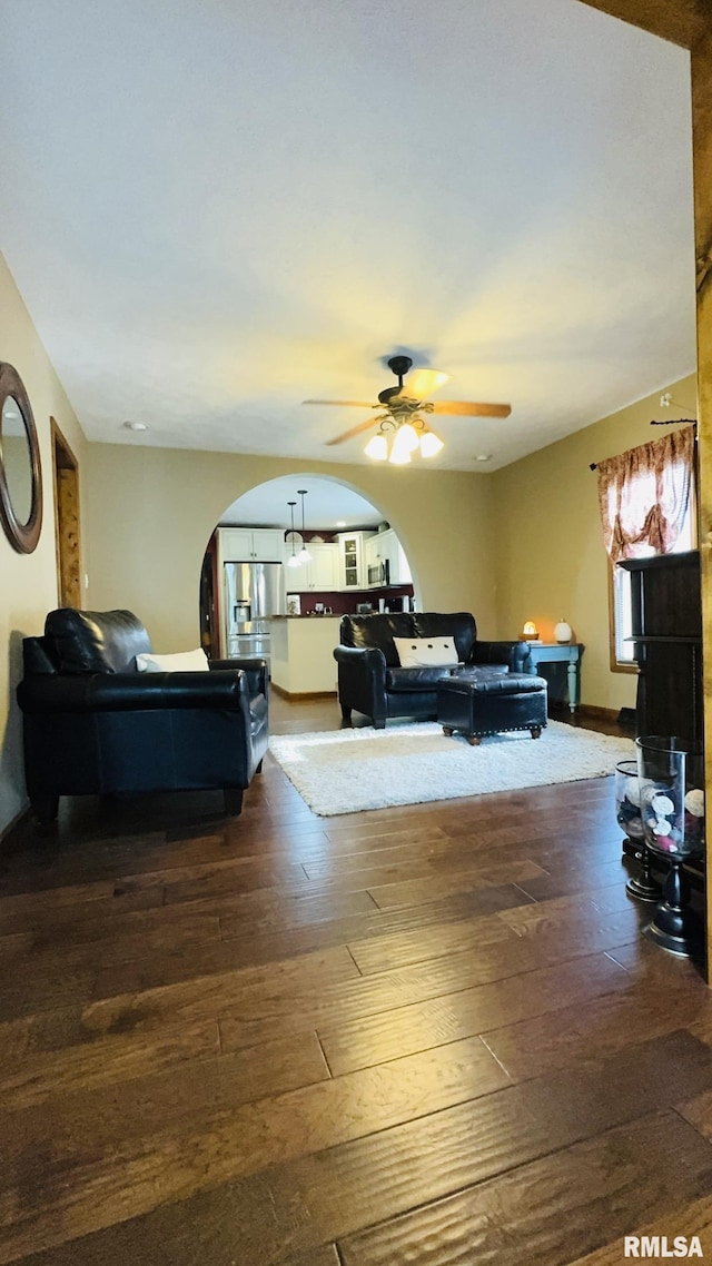 105 E Yung St, Sesser, IL 62884 - living area featuring arched walkways, dark wood finished floors, and a ceiling fan