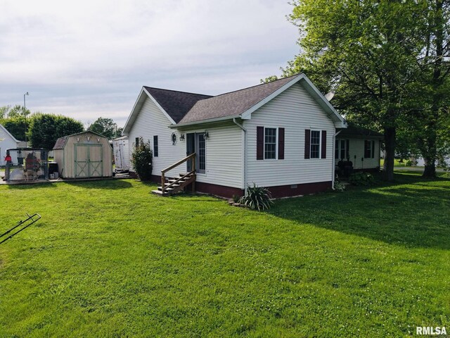 105 E Yung St, Sesser, IL 62884 - back of house with entry steps, a storage shed, crawl space, and a lawn