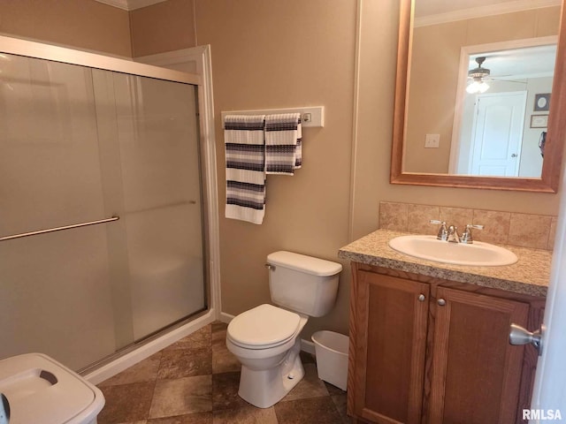 312 Beulah St, Christopher, IL 62822 - bathroom with a shower stall, toilet, vanity, ornamental molding, and a ceiling fan