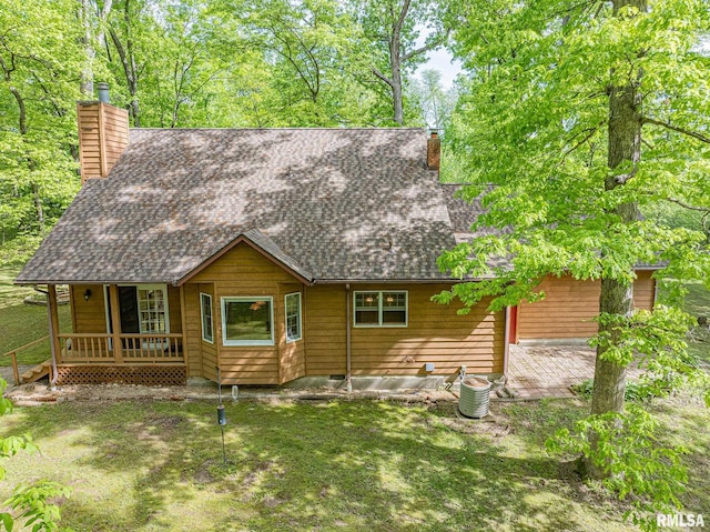 15751 E Tolle Rd, Mount Vernon, IL 62864 - view of front of house featuring a chimney, roof with shingles, a porch, a patio, and a front lawn