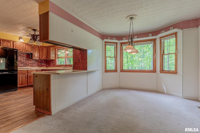 15751 E Tolle Rd, Mount Vernon, IL 62864 - kitchen with freestanding refrigerator, a textured ceiling, brown cabinetry, healthy amount of natural light, and a peninsula