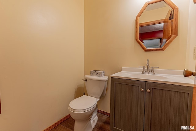 15751 E Tolle Rd, Mount Vernon, IL 62864 - half bathroom featuring wood finished floors, toilet, vanity, and baseboards