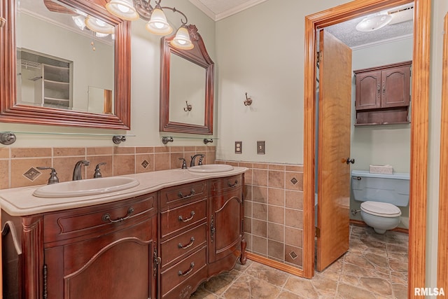15751 E Tolle Rd, Mount Vernon, IL 62864 - full bath featuring tile walls, crown molding, double vanity, wainscoting, and toilet