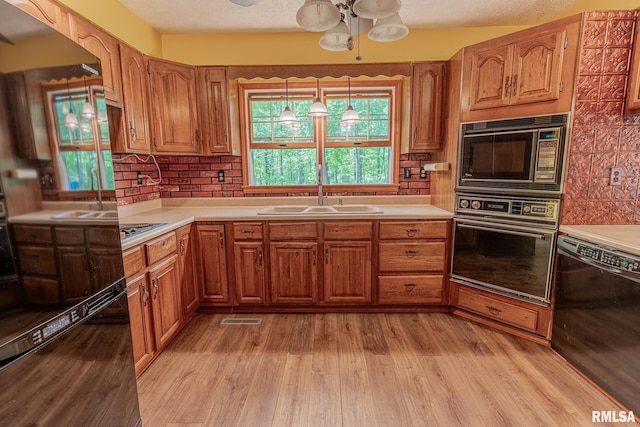 15751 E Tolle Rd, Mount Vernon, IL 62864 - kitchen featuring black appliances, a sink, and brown cabinetry