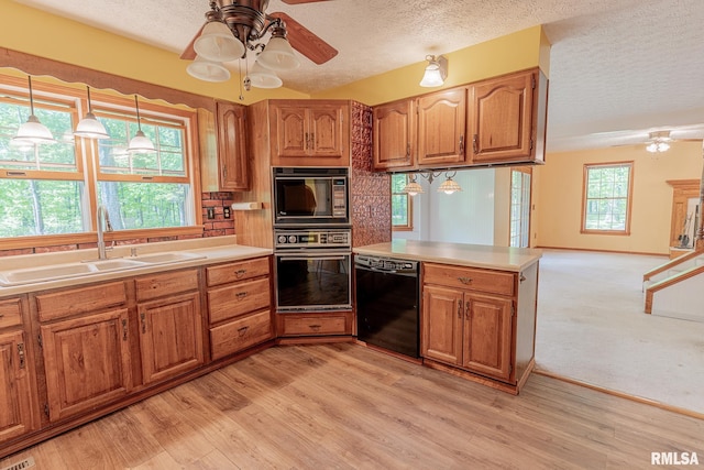 15751 E Tolle Rd, Mount Vernon, IL 62864 - kitchen with black appliances, a ceiling fan, a sink, a textured ceiling, and a peninsula