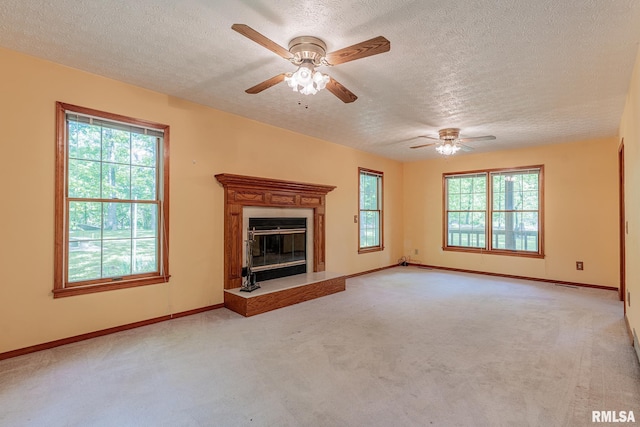 15751 E Tolle Rd, Mount Vernon, IL 62864 - unfurnished living room featuring a textured ceiling, ceiling fan, carpet, and plenty of natural light