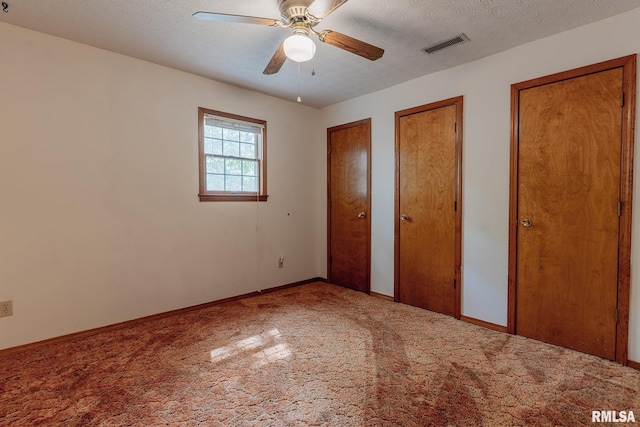 15751 E Tolle Rd, Mount Vernon, IL 62864 - unfurnished bedroom featuring multiple closets, carpet, baseboards, and a ceiling fan