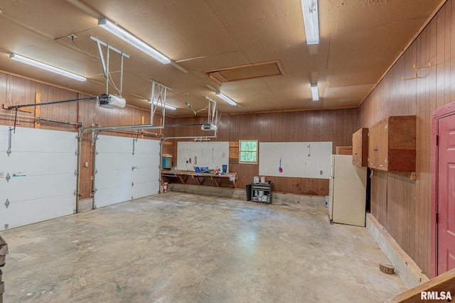 15751 E Tolle Rd, Mount Vernon, IL 62864 - garage with freestanding refrigerator, a garage door opener, and wood walls