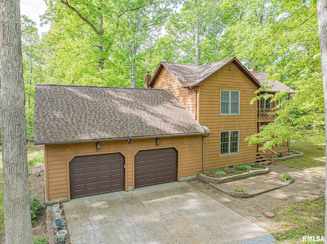 15751 E Tolle Rd, Mount Vernon, IL 62864 - view of front of property with roof with shingles, a garage, concrete driveway, and a chimney