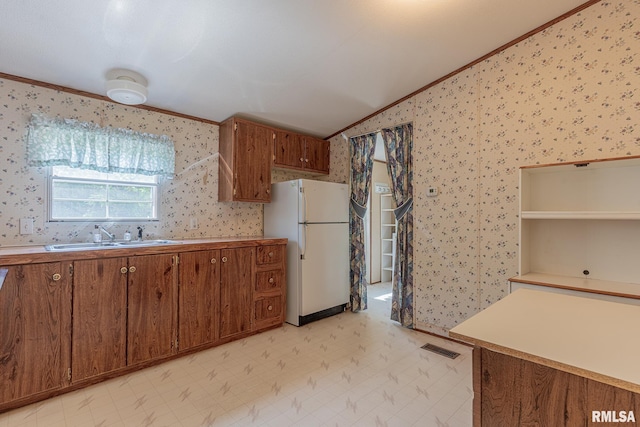 15751 E Tolle Rd, Mount Vernon, IL 62864 - kitchen with freestanding refrigerator, a sink, ornamental molding, wallpapered walls, and vaulted ceiling