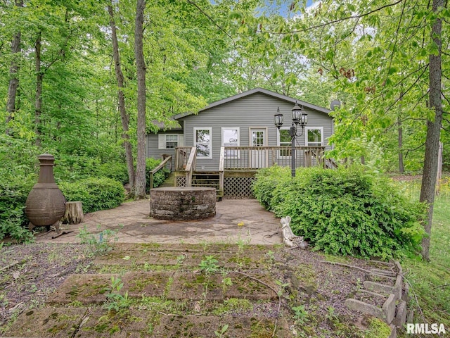 2234 Cascade Ln, Centralia, IL 62801 - back of property featuring a wooden deck, a patio, and an outdoor fire pit