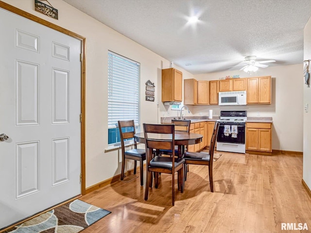 2234 Cascade Ln, Centralia, IL 62801 - kitchen featuring white appliances, a textured ceiling, light wood-style floors, baseboards, and light countertops