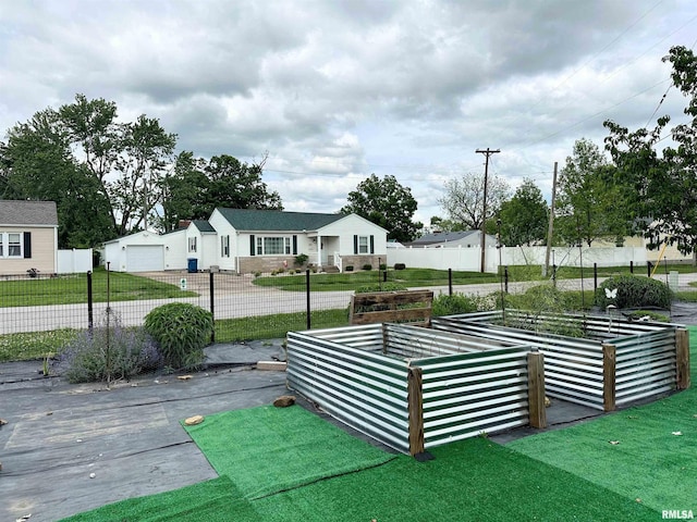 401 S 1st St, Marion, IL 62959 - view of home's community featuring a vegetable garden and a detached garage