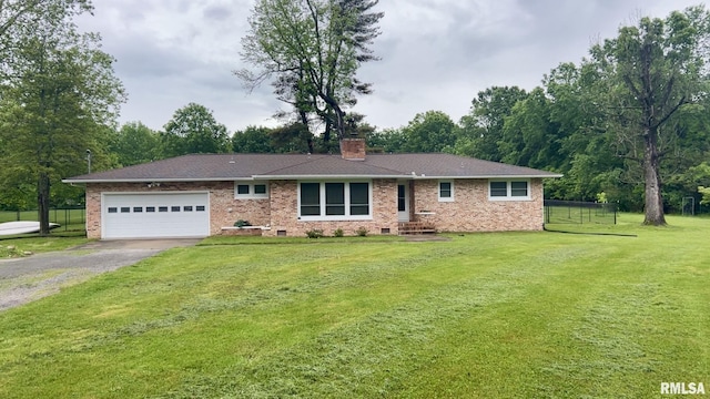 112 Prairie Rd, Carterville, IL 62918 - ranch-style home with gravel driveway, an attached garage, a chimney, and brick siding
