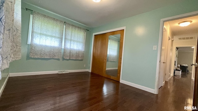 112 Prairie Rd, Carterville, IL 62918 - unfurnished bedroom with hardwood / wood-style floors, baseboards, and a closet